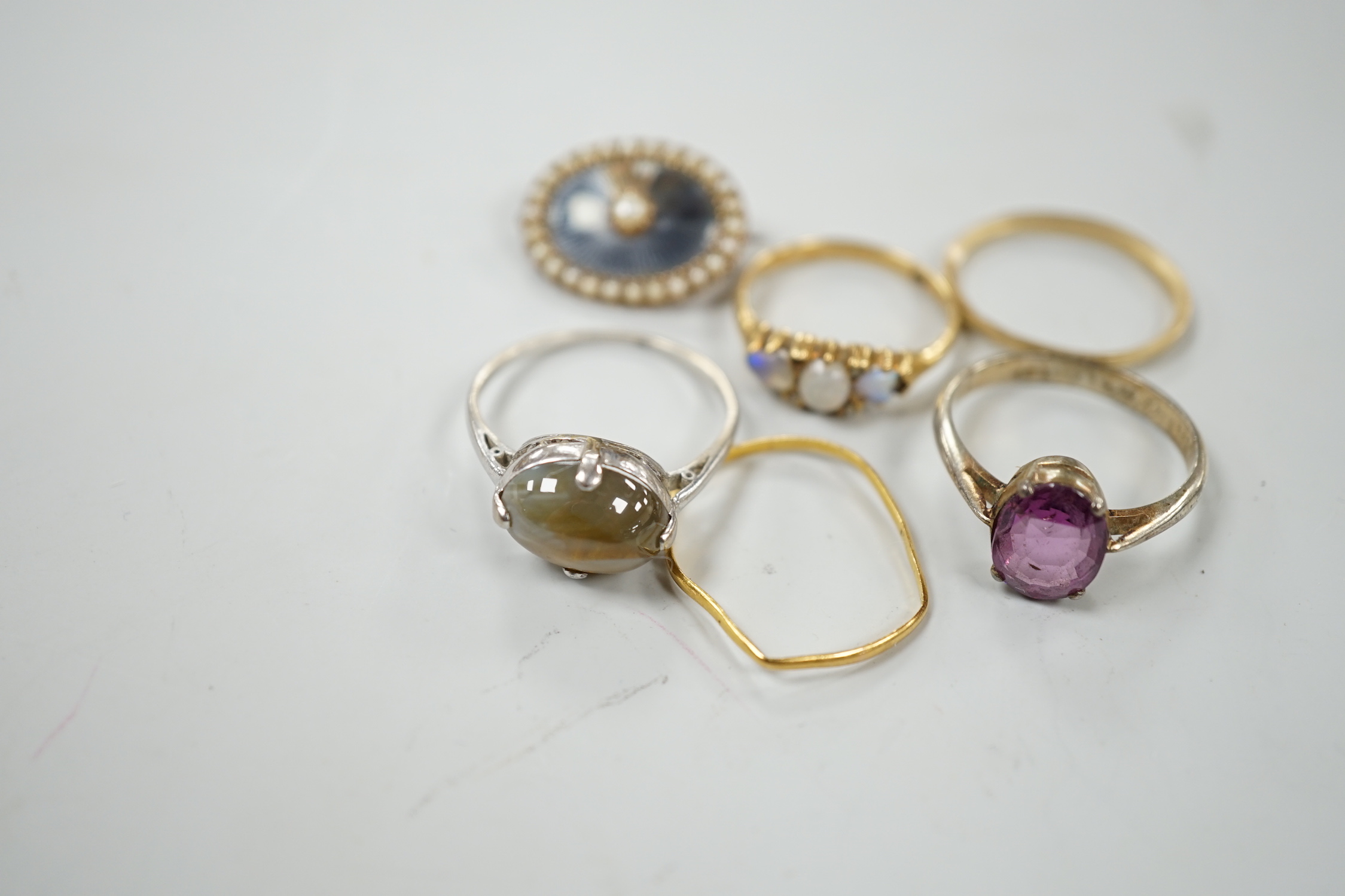 An early 20th century 18ct and three stone white opal set half hoop ring, with diamond chip spacers(one missing), size M, gross weight 2.5 grams, a 9ct band, 1 grams, a 22ct band(a.f.), 0.8 grams, two other rings includi